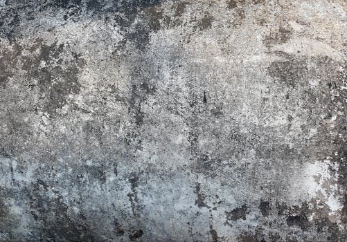 Close-up of textured cement surface ideal for backgrounds and design.